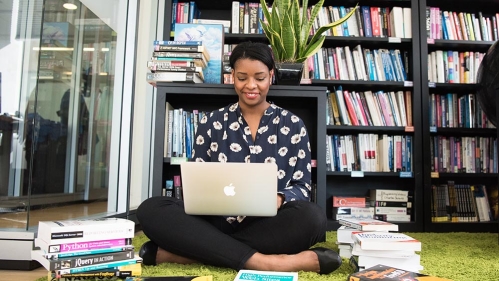 School Librarianship - woman on floor with laptop and books