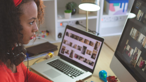 A woman reviewing digital images on a computer screen.