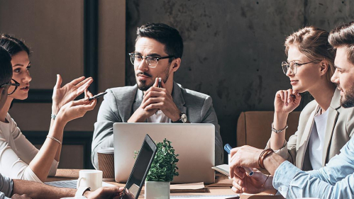 Workers in a meeting around a table