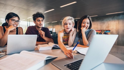 Technology, Information, and Management - students looking a laptops
