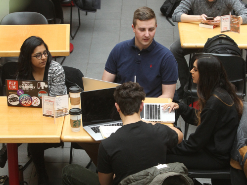 Students discussing around table