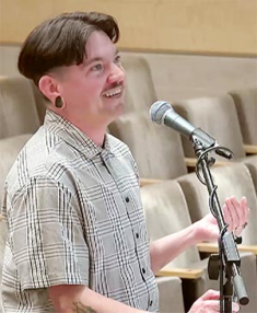 Jeanie Austin is smiling while holding a microphone. 
